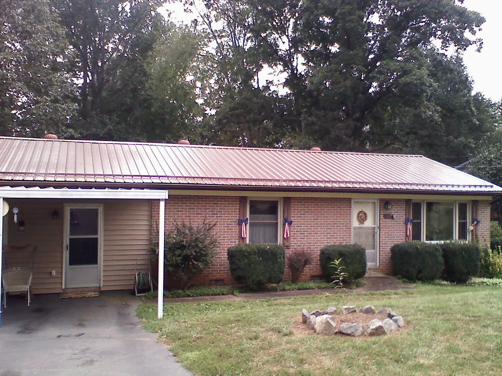 Bronze metal roof and carport on a brick ranch home — Roof Repair work by our crew in Brownsboro