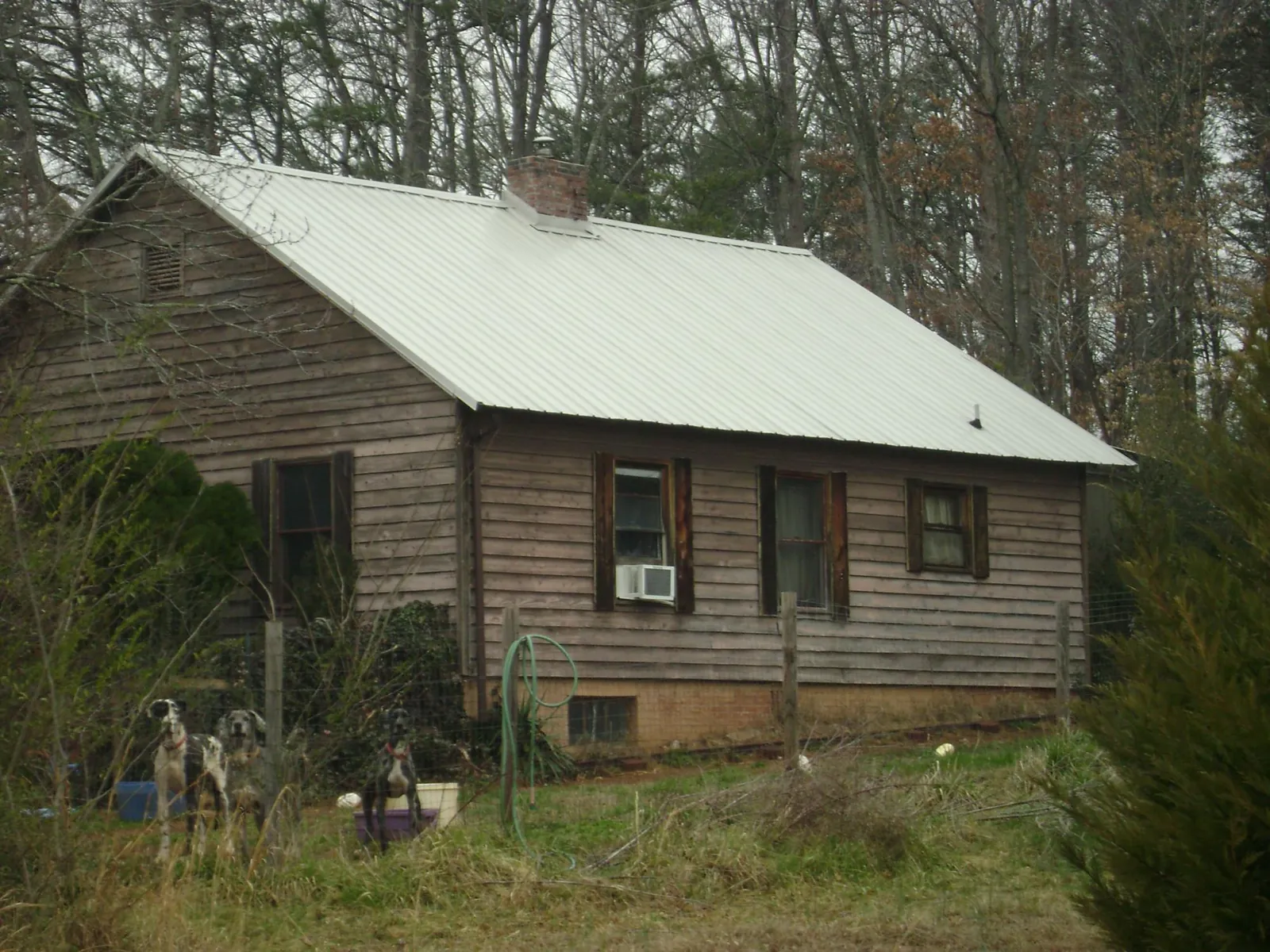 White metal roof on an old wood sided farmhouse, from a Metal Roof Installation job in Brownsboro
